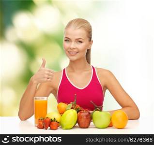 fitness, healthcare and diet concept - smiling young woman with organic food or fruits on table shwoing thumbs up