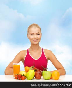 fitness, healthcare and diet concept - smiling young woman with organic food or fruits on table