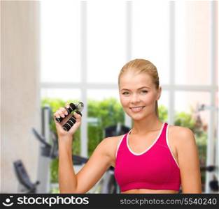 fitness, healthcare and dieting concept - beautiful sporty woman with hand expander