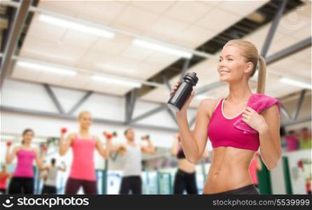 fitness, healthcare and dieting concept - smiling sporty woman drinking water from sportsman bottle
