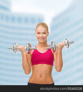 fitness, healthcare and dieting concept - young sporty woman lifting steel dumbbells