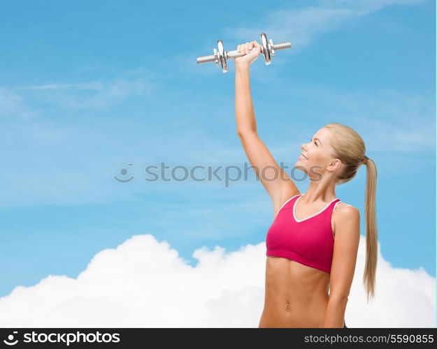 fitness, healthcare and dieting concept - young sporty woman with heavy steel dumbbell