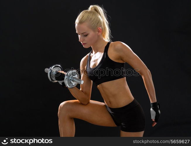 fitness, healthcare and dieting concept - young sporty woman with heavy steel dumbbell