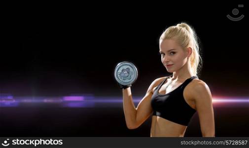 fitness, healthcare and dieting concept - young sporty woman with heavy steel dumbbell