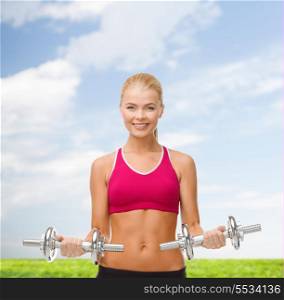 fitness, healthcare and dieting concpt - young sporty woman with heavy steel dumbbells