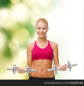 fitness, healthcare and dieting concpt - young sporty woman with heavy steel dumbbells