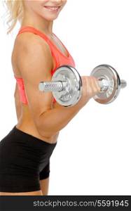 fitness, healthcare and exercise concept - close up of young sporty woman with heavy steel dumbbell