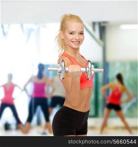 fitness, healthcare and exercise concept - young sporty woman with heavy steel dumbbell