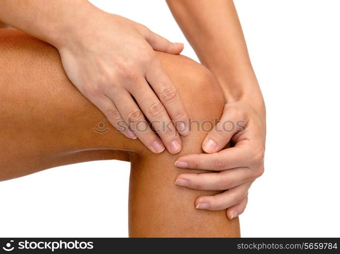 fitness, healthcare and medicine concept - close up of female hands holding knee