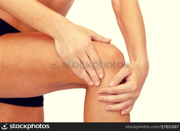 fitness, healthcare and medicine concept - close up of female hands holding knee