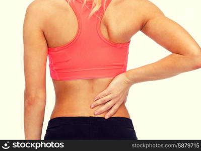 fitness, healthcare and medicine concept - close up of sporty woman touching her back