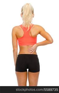 fitness, healthcare and medicine concept - sporty woman touching her back