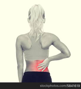 fitness, healthcare and medicine concept - sporty woman touching her back