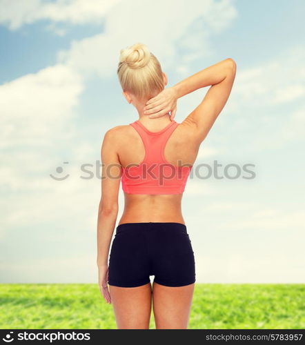 fitness, healthcare and medicine concept - sporty woman touching her neck