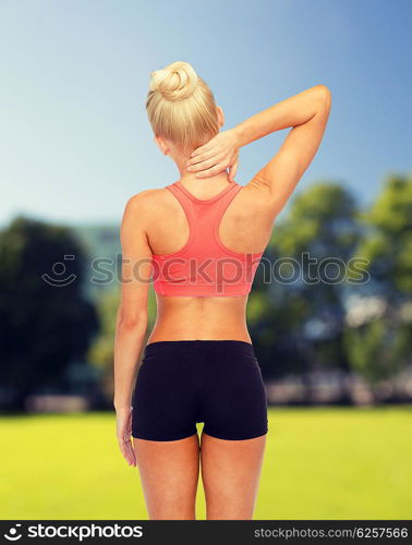 fitness, healthcare and medicine concept - sporty woman touching her neck