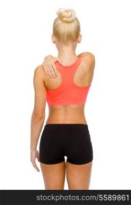 fitness, healthcare and medicine concept - sporty woman touching her shoulder
