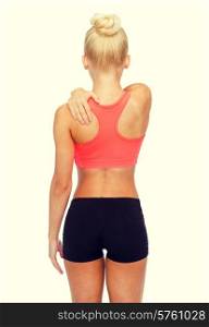 fitness, healthcare and medicine concept - sporty woman touching her shoulder