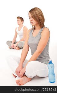 Fitness - Healthy couple stretching after training on white background