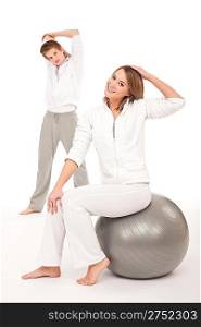 Fitness - Healthy couple stretching after training on white background
