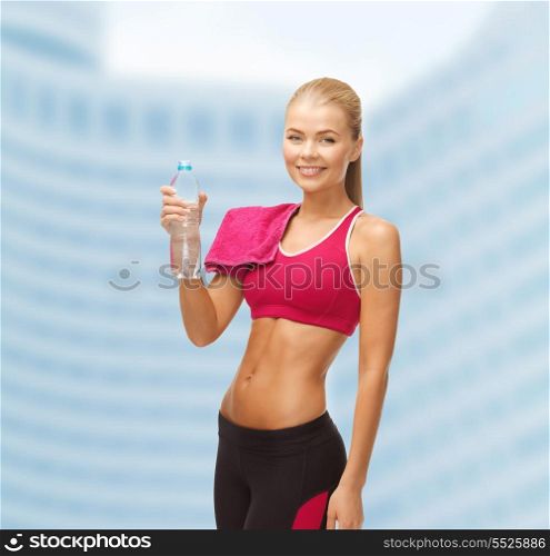fitness, heatl and diet concept - sporty woman with bottle of water and towel