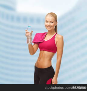 fitness, heatl and diet concept - sporty woman with bottle of water and towel