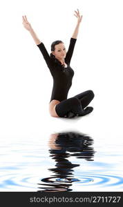 fitness in black leotard on white sand