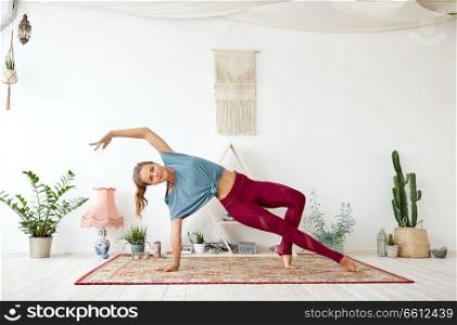 fitness, people and healthy lifestyle concept - young woman doing yoga at studio. young woman doing yoga at studio