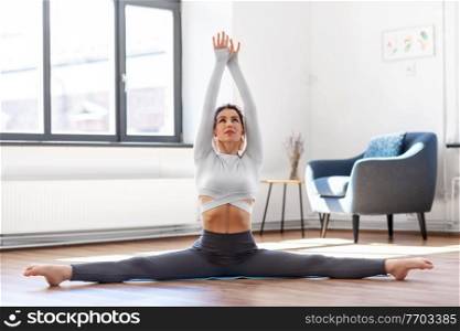 fitness, people and healthy lifestyle concept - young woman doing yoga at studio. young woman doing yoga at studio