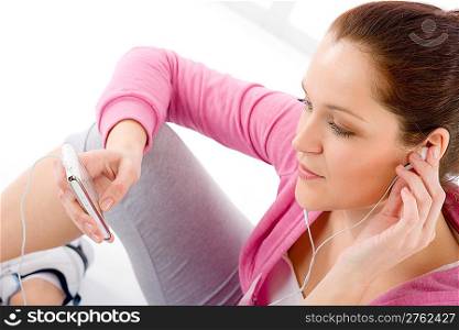 Fitness portrait of woman listen music mp3 relax in gym