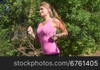 Fitness routine for women - athletic girl runner jogging along road