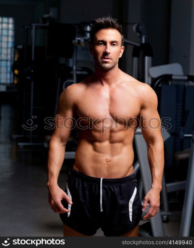 fitness shaped muscle man posing on dark gym