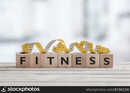 Fitness sign with yellow measure tape on a table