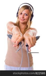 Fitness, slimming, loosing weight concept. Happy blonde woman holding skipping rope, wearing big headphones and sportswear. Studio shot isolated.. Blonde woman holding skipping rope wearing headphones