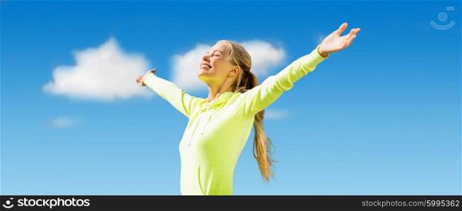 fitness, sport, achievement, people and emotions concept - happy sporty woman enjoying sun and freedom over blue sky and clouds background