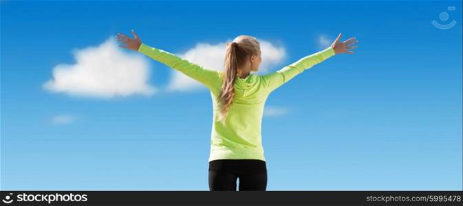 fitness, sport, achievement, people and emotions concept - happy sporty woman enjoying sun and freedom over blue sky and clouds background from back