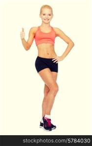 fitness, sport and diet concept - beautiful athletic woman in sportswear showing thumbs up