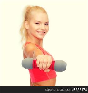 fitness, sport and diet concept - smiling beautiful sporty woman, focus on dumbbell