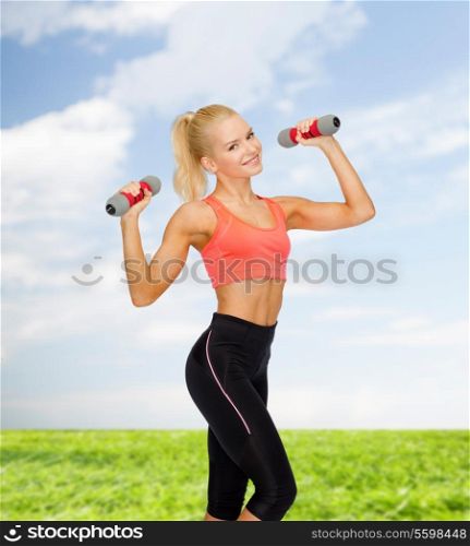 fitness, sport and diet concept - smiling beautiful sporty woman with dumbbells