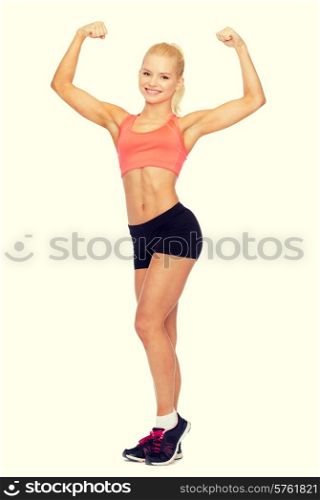 fitness, sport and diet concept - smiling sporty woman flexing her biceps