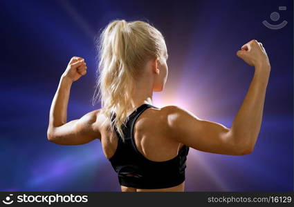 fitness, sport and diet concept - sporty woman form the back flexing her biceps