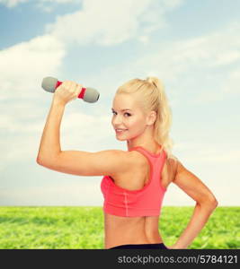 fitness, sport and diet concept - young sporty woman with light dumbbell