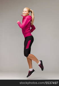 fitness, sport and dieting concept - beautiful sporty woman running or jumping