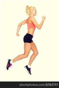 fitness, sport and dieting concept - beautiful sporty woman running or jumping