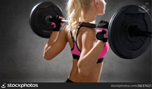 fitness, sport and dieting concept - close up of sporty woman exercising with barbell from back over concrete wall background