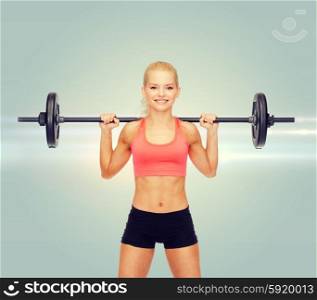 fitness, sport and dieting concept - smiling sporty woman exercising with barbell