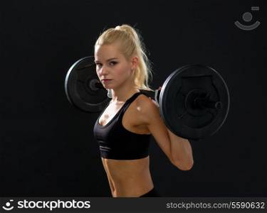 fitness, sport and dieting concept - sporty woman exercising with barbell
