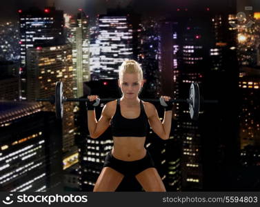 fitness, sport and dieting concept - sporty woman exercising with barbell