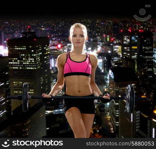 fitness, sport and dieting concept - sporty woman exercising with barbell