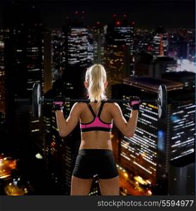 fitness, sport and dieting concept - sporty woman exercising with barbell and weights from back