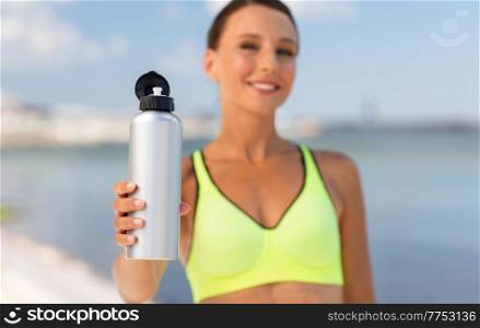 fitness, sport and healthy lifestyle concept - close up of happy smiling young woman with bottle of water outdoors. close up of woman with bottle of water outdoors